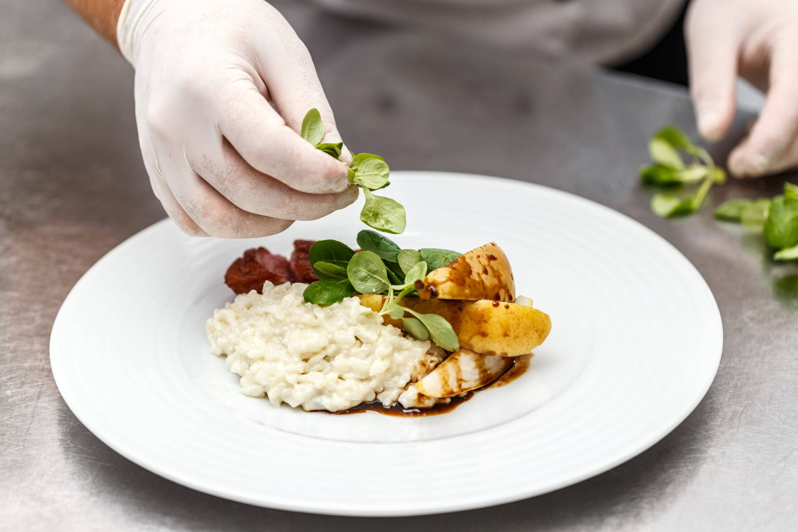 Chef plating a refined dish