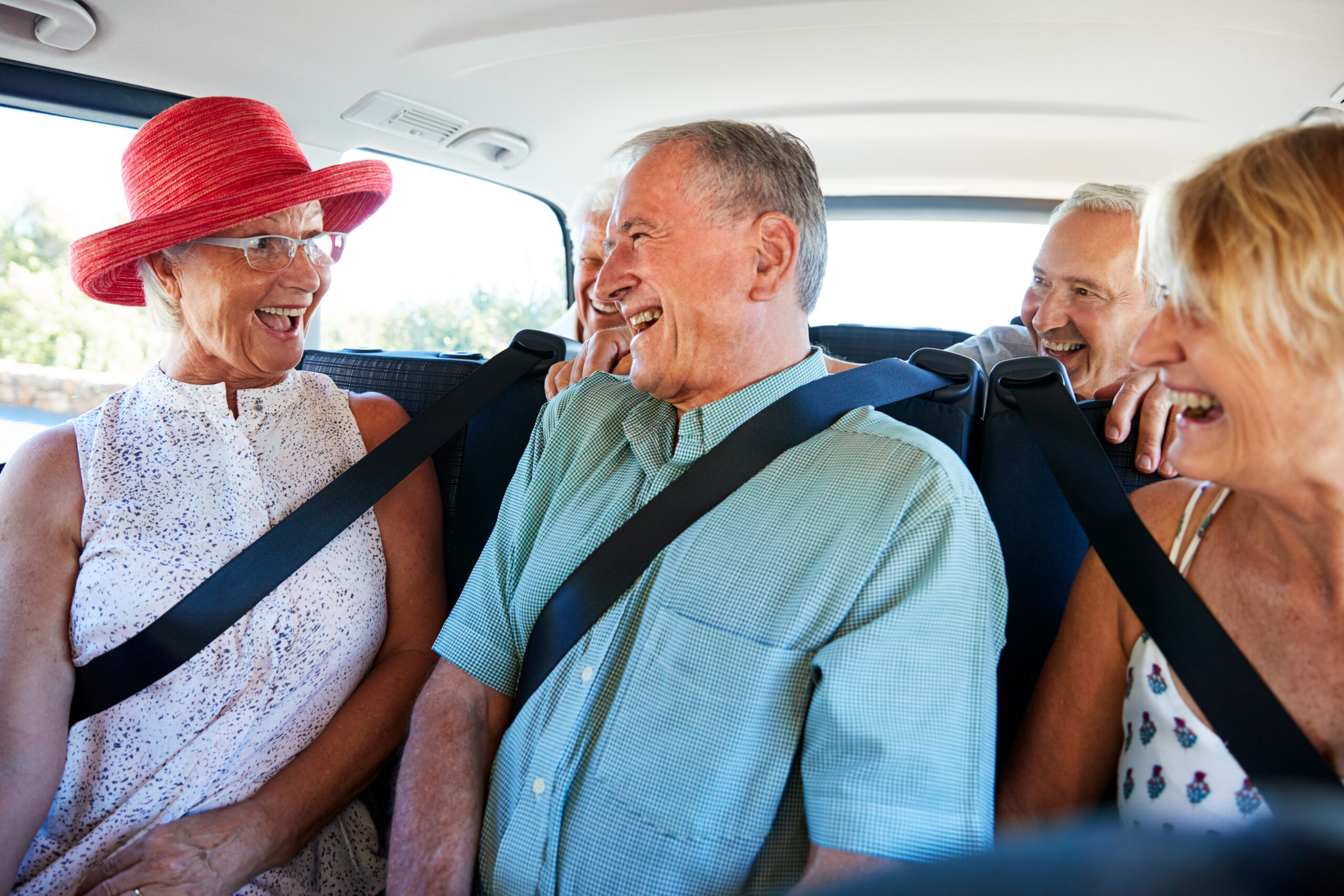 Seniors laughing together in a car