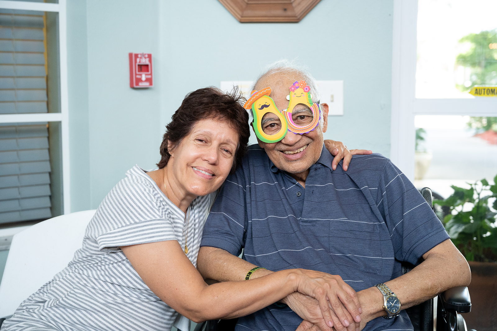 An older adult and family member together in a bright, welcoming space